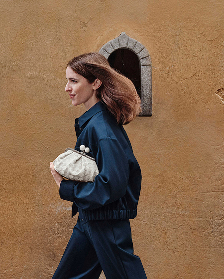 写真:Weekend Max Mara ポップアップストア。ネイビーのセットアップに幾何学模様のパスティチーノ バッグを合わせたスタイル